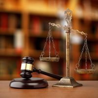 Gavel And Scales Of Justice On Desk In Law Office