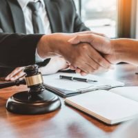 Businessman shaking hands to seal a deal Judges male lawyers Consultation legal services Consulting in regard to the various contracts to plan the case in court.